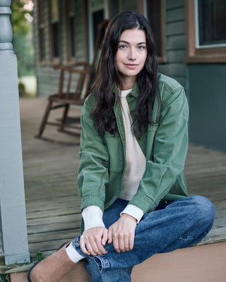 Woman in oversized green workshirt