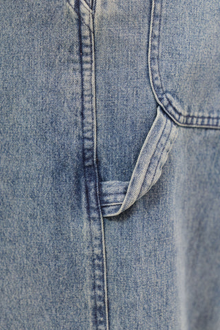 Close-up of a blue denim fabric with stitching detail